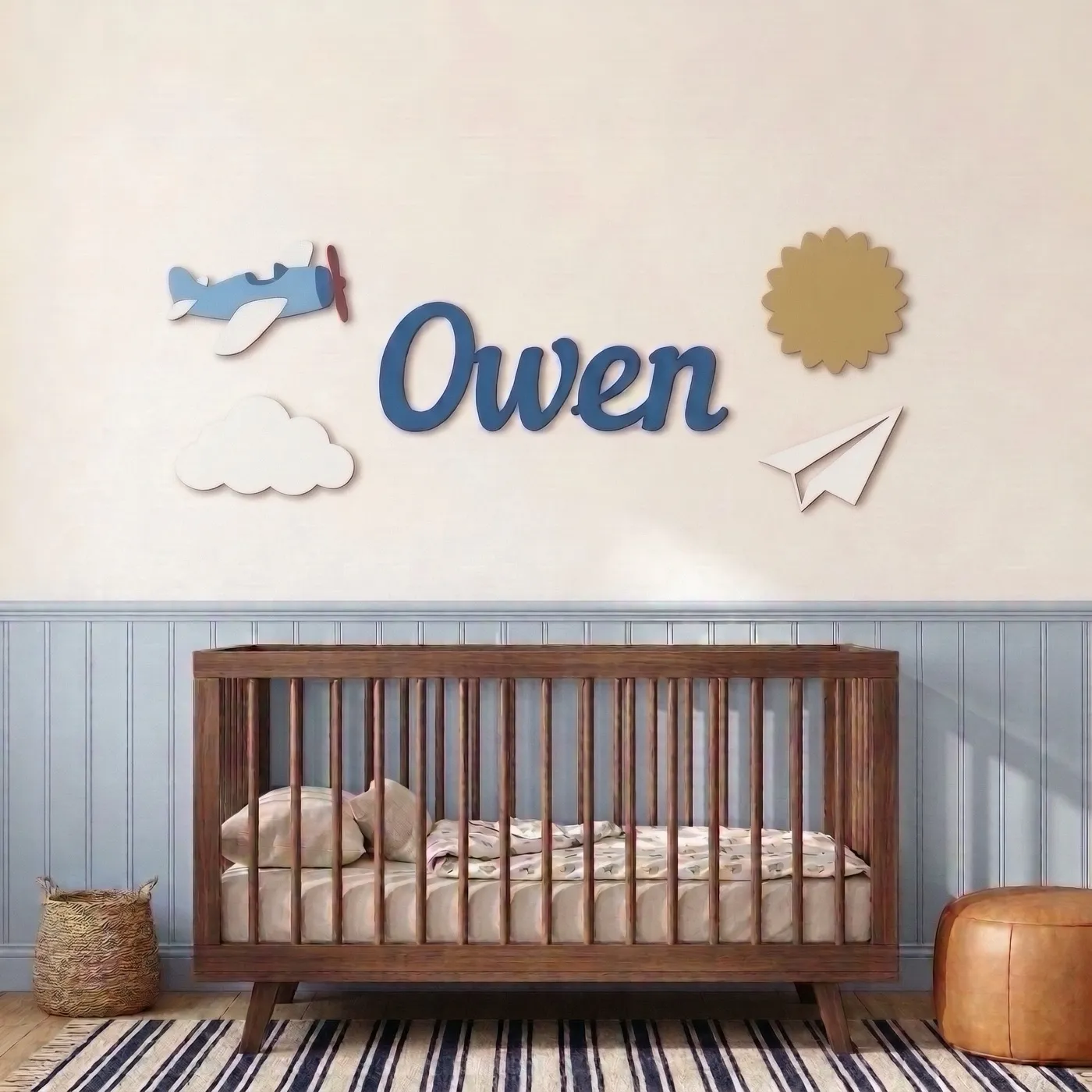 Airplane sign with the name Owen above a crib
